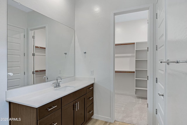 2968 E Tundra Ln, San Tan Valley, AZ 85143 - bathroom featuring a spacious closet, vanity, and baseboards