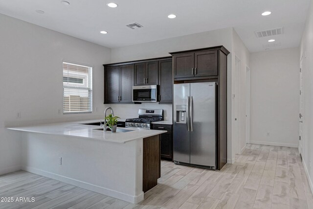 2968 E Tundra Ln, San Tan Valley, AZ 85143 - kitchen with a sink, visible vents, stainless steel appliances, and dark brown cabinets