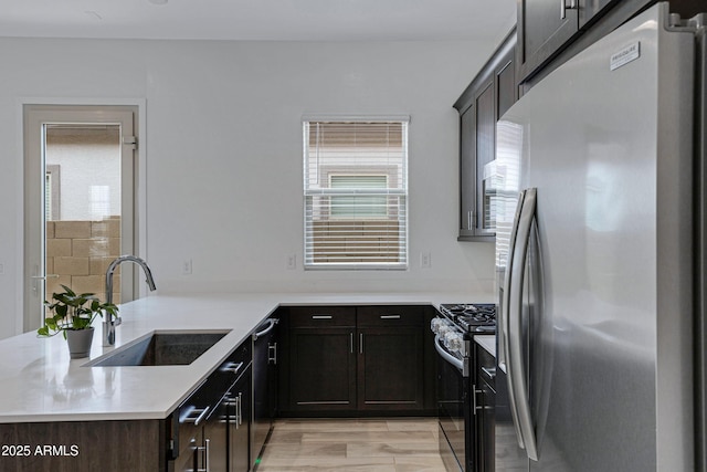 2968 E Tundra Ln, San Tan Valley, AZ 85143 - kitchen with light countertops, stainless steel appliances, a sink, a peninsula, and dark brown cabinets