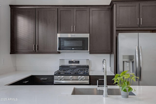 2968 E Tundra Ln, San Tan Valley, AZ 85143 - kitchen with light countertops, dark brown cabinets, and appliances with stainless steel finishes