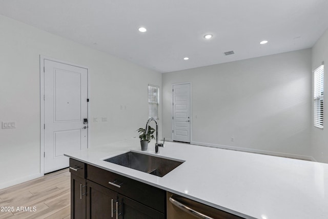 2968 E Tundra Ln, San Tan Valley, AZ 85143 - kitchen with light countertops, stainless steel dishwasher, a sink, light wood finished floors, and visible vents