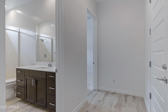 2968 E Tundra Ln, San Tan Valley, AZ 85143 - bathroom featuring a shower stall, wood tiled floor, toilet, and vanity