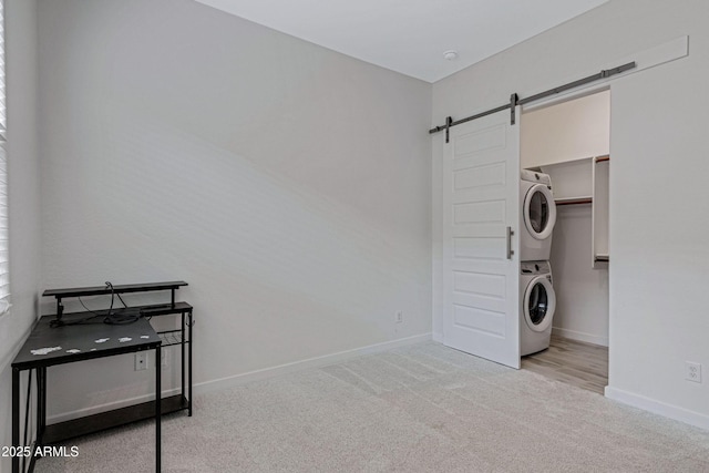 2968 E Tundra Ln, San Tan Valley, AZ 85143 - washroom with stacked washer / dryer, carpet floors, baseboards, and a barn door