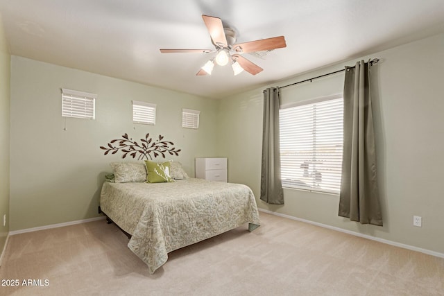 bedroom with light colored carpet and ceiling fan