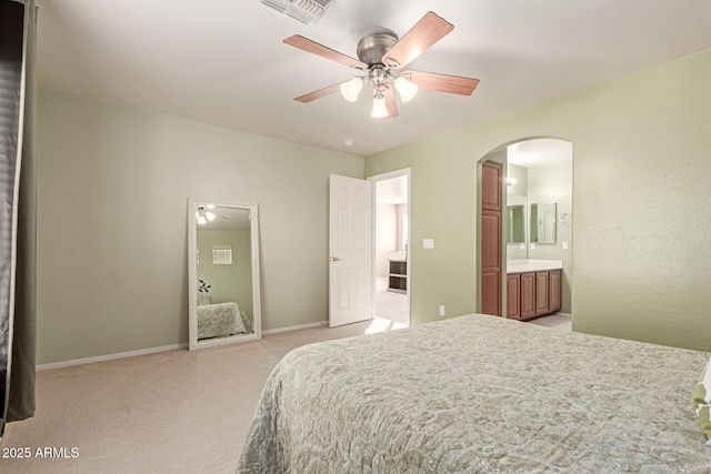 bedroom with ensuite bathroom and ceiling fan