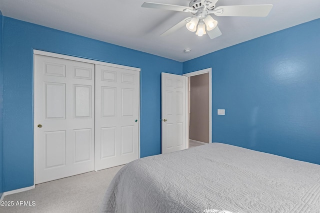 carpeted bedroom with a closet and ceiling fan