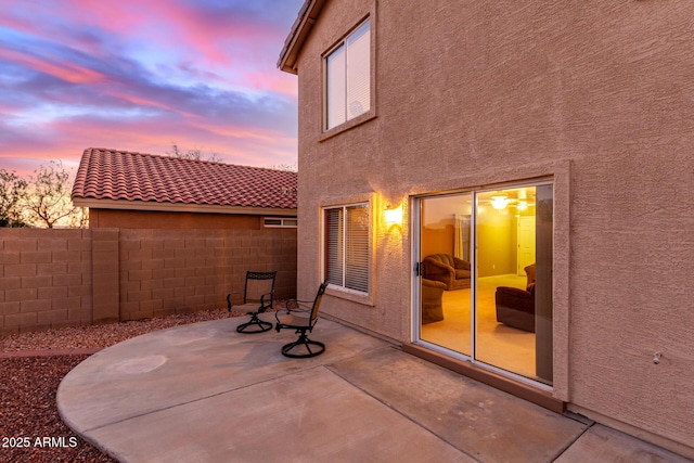 view of patio terrace at dusk