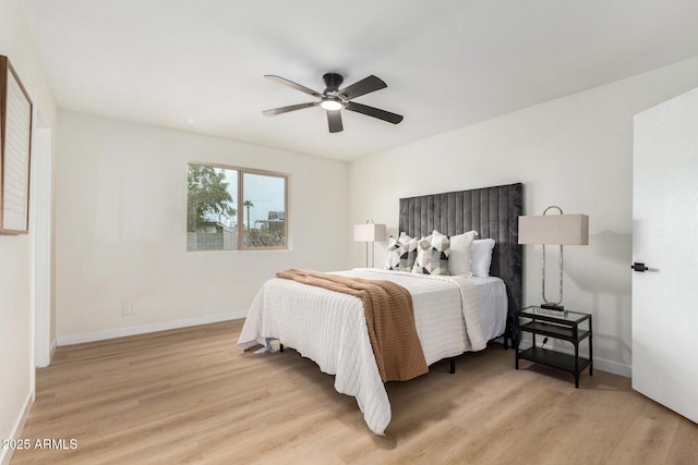 bedroom with ceiling fan and light hardwood / wood-style flooring