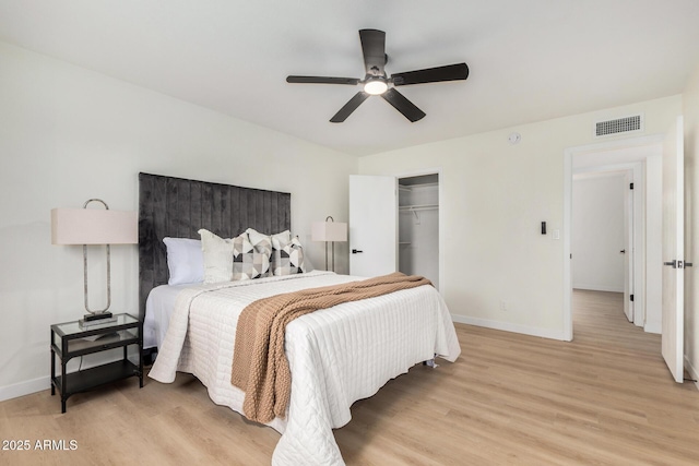 bedroom with a closet, ceiling fan, and light hardwood / wood-style flooring