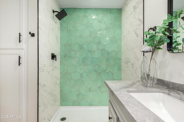 bathroom featuring vanity and a tile shower