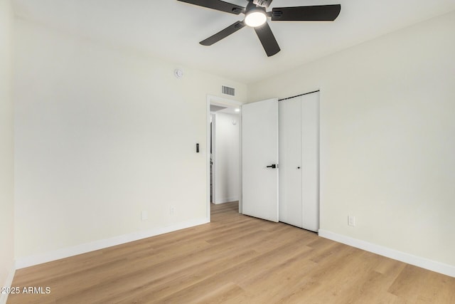 unfurnished bedroom with ceiling fan, light hardwood / wood-style floors, and a closet