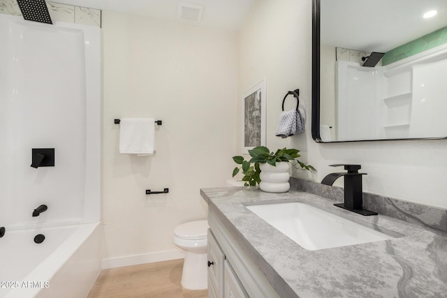 full bathroom with vanity, wood-type flooring, bathing tub / shower combination, and toilet