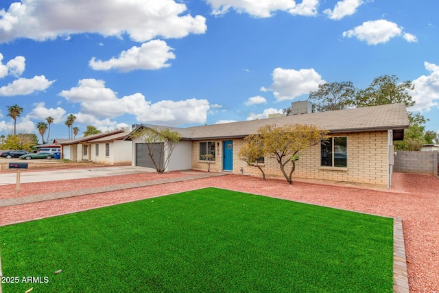 view of front of house featuring a garage and a front lawn