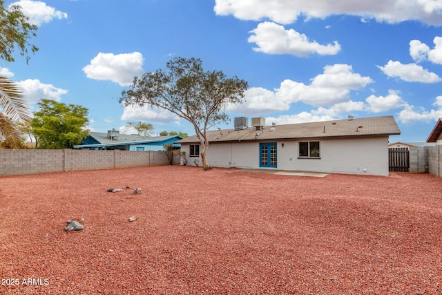 back of property with a patio and central AC