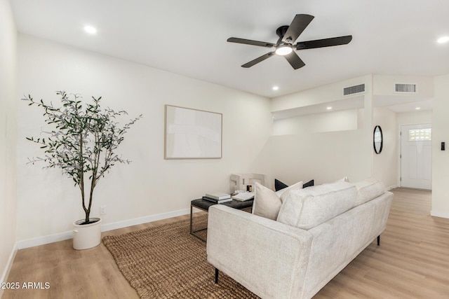 living room featuring ceiling fan and light hardwood / wood-style floors