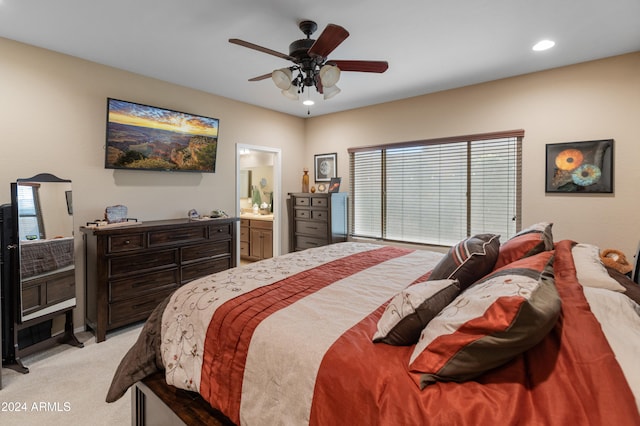 carpeted bedroom featuring multiple windows, ceiling fan, and connected bathroom