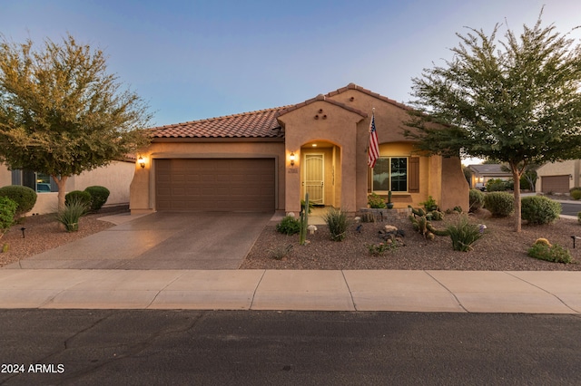 mediterranean / spanish-style home with a garage