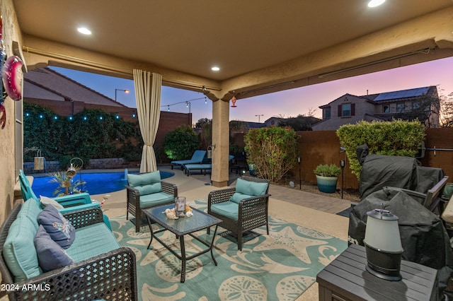 patio terrace at dusk featuring outdoor lounge area