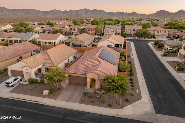 aerial view at dusk featuring a mountain view