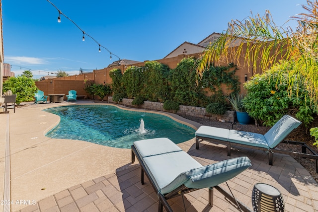 view of pool with pool water feature and a patio area