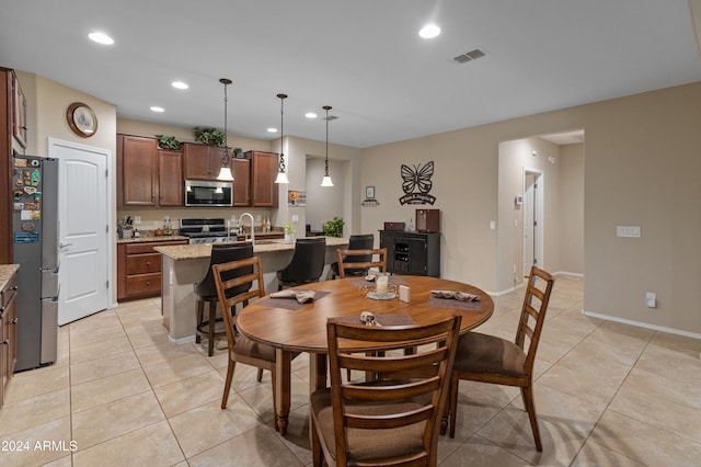 tiled dining space featuring sink