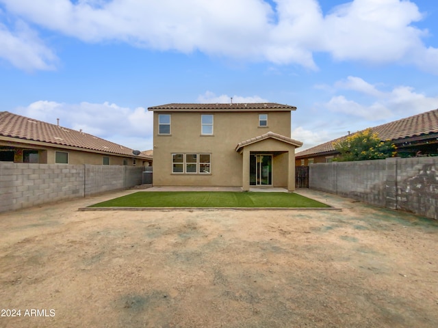 back of house with a yard