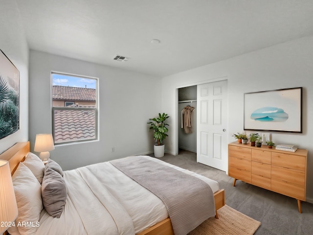 bedroom featuring dark carpet and a closet