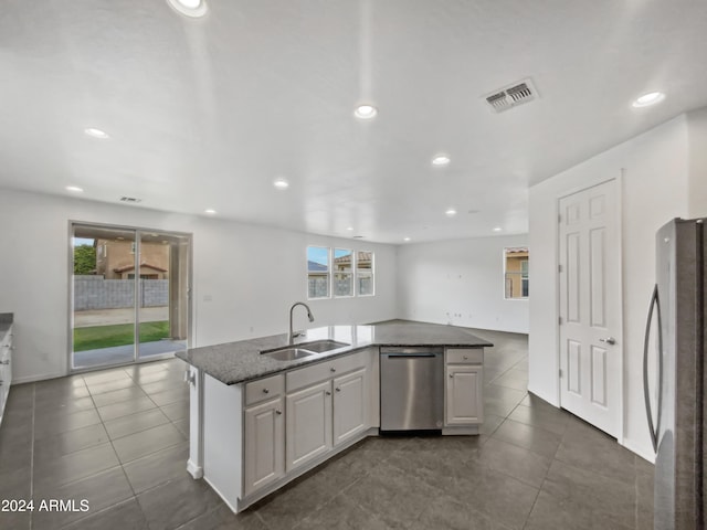 kitchen with stainless steel appliances, a kitchen island with sink, a healthy amount of sunlight, and sink