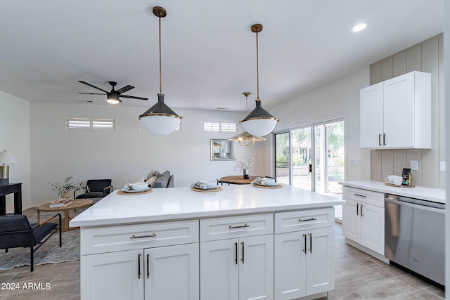 kitchen with a kitchen island, white cabinets, light countertops, dishwasher, and pendant lighting