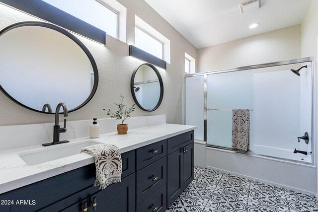 bathroom featuring combined bath / shower with glass door, tile patterned floors, and vanity