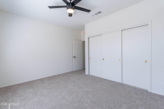 unfurnished bedroom featuring a ceiling fan, a closet, visible vents, and carpet flooring