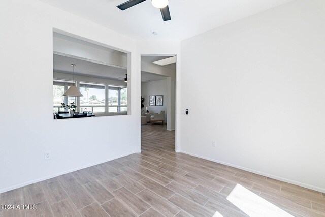 unfurnished living room with ceiling fan and light wood-type flooring