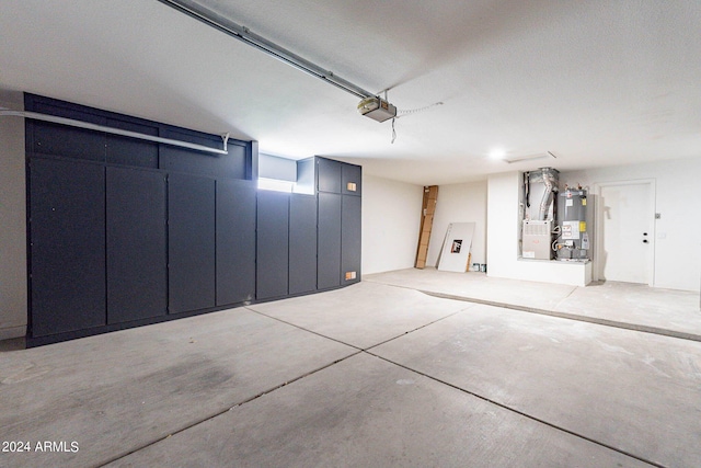 garage with heating unit, electric water heater, and a garage door opener