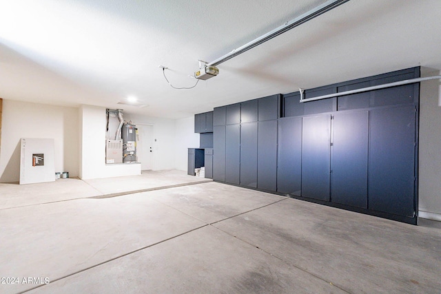 garage featuring a garage door opener and water heater