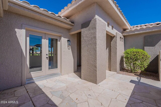 entrance to property with a patio area and french doors