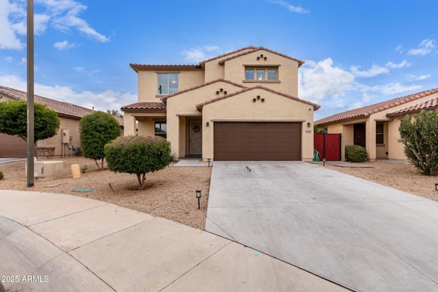 16789 W Moreland St, Goodyear, AZ 85338 - mediterranean / spanish-style house featuring a tiled roof, an attached garage, concrete driveway, and stucco siding