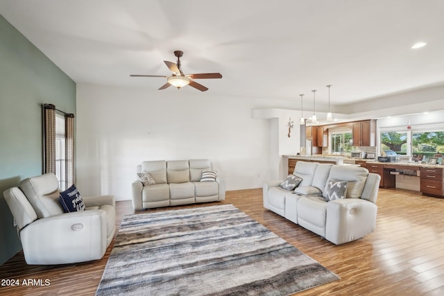 living room with light wood-type flooring and ceiling fan