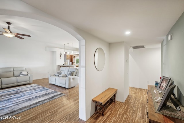 living room featuring ceiling fan and hardwood / wood-style floors