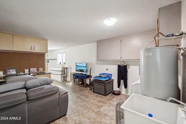 interior space featuring sink, water heater, and a textured ceiling