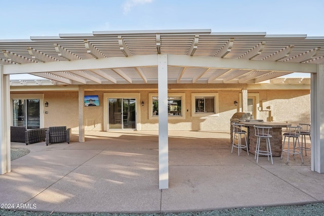 view of patio / terrace with a pergola, grilling area, and an outdoor bar