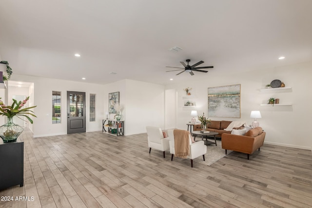 living room featuring ceiling fan and light hardwood / wood-style floors