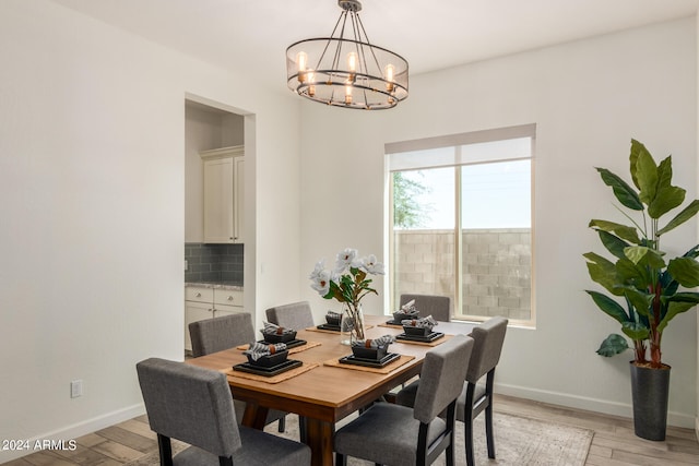 dining space featuring a notable chandelier and light hardwood / wood-style floors