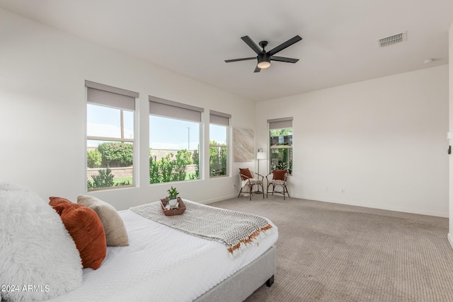 bedroom featuring ceiling fan and carpet