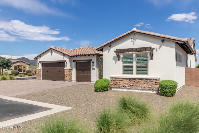 mediterranean / spanish-style home with a garage