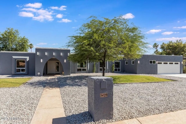 pueblo-style home with a garage