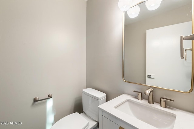 bathroom with toilet and vanity