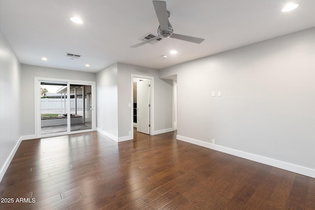 spare room featuring ceiling fan and dark wood-type flooring