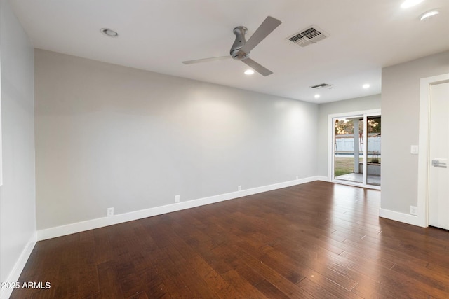 unfurnished room with ceiling fan and dark wood-type flooring