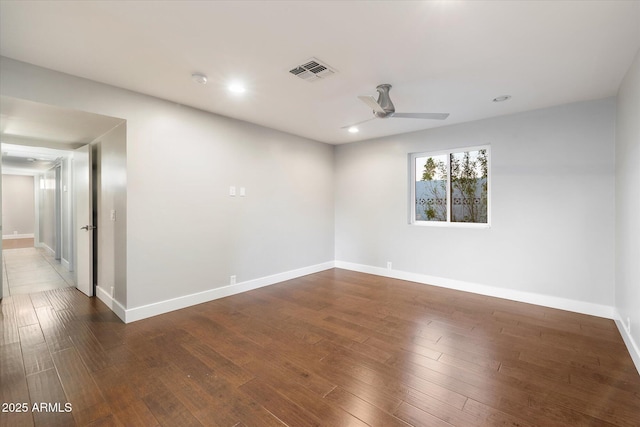 spare room with ceiling fan and dark hardwood / wood-style flooring