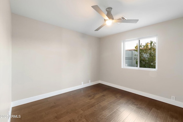 unfurnished room with ceiling fan and dark wood-type flooring